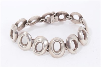 Lot 169 - Sterling silver articulated bracelet comprising pierced oval panels