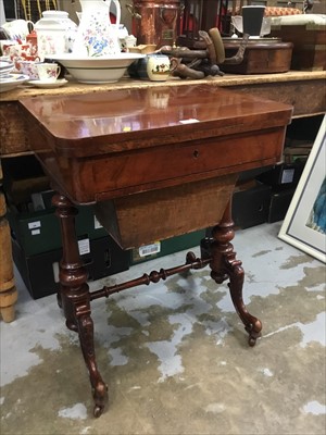 Lot 152 - Mid 19th century mahogany sewing table with fold over top, drawer and needlework bag below on end standards.