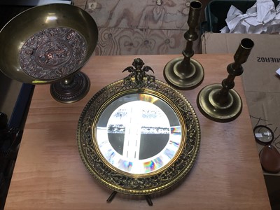 Lot 336 - Victorian brass circular easel mirror with cherub mount, pair brass candlesticks and brass and copper tazza (4)