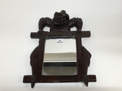 Lot 286 - Unusual 19th century carved wood mirror with climbing man cresting