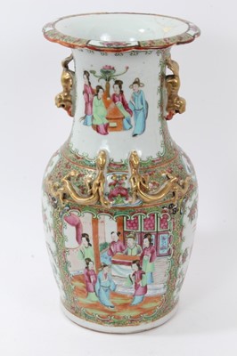 Lot 184 - Late 19th century Chinese famille rose baluster vase, painted in the Canton style with figural scenes, flowers and birds, with moulded foo dog handles and dragons, 33.5cm height