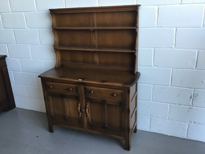 Lot 24 - Ercol 'Golden Dawn' two height dresser with raised plate rack above, two draws and two panelled doors below, 122cm in length, 161cm in height and 47cm depth