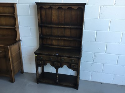 Lot 25 - Manner of Titchmarsh & Goodwin- Good quality reproduction oak two height dress of small proportions with raised panelled back above and assortment of 5 draws with shelved under tier, 92cm in length...