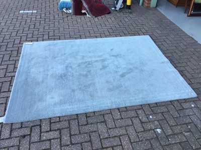 Lot 42 - Large Chinese wash rug with geometric and floral decoration on green ground, 366 x 270cm together with another rug Contemporary pale blue rug, measuring 241 x 175cm (2)