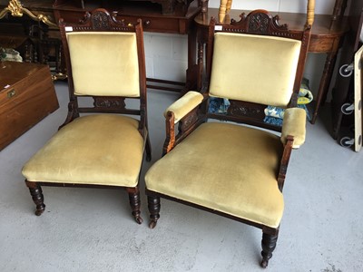 Lot 54 - Edwardian carved wood armchair with green velvet upholstery and padded arms, on turned legs together with a matching easy chair (2)