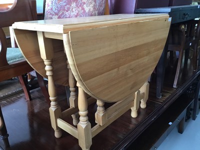 Lot 95 - Contemporary pine drop leaf kitchen table on turned legs joined by stretchers, 92cm x 73cm x 47cm (flaps down)