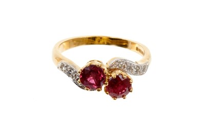 Lot 436 - 18ct gold two ruby cross over stone ring decorated with chip diamonds on flank