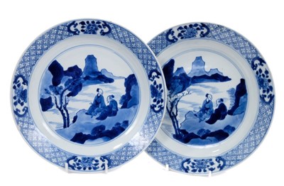 Lot 194 - Good pair of Chinese blue and white porcelain dishes, each painted with two figures in a rocky landscape