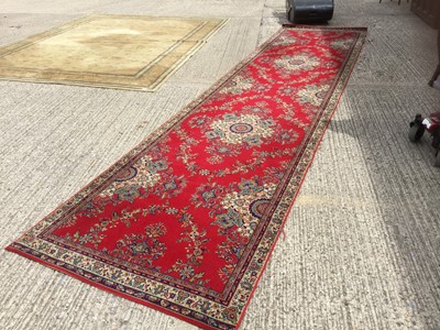 Lot 1028 - Administer Wilton Rug on red ground, measuring approx 553 x 128cm