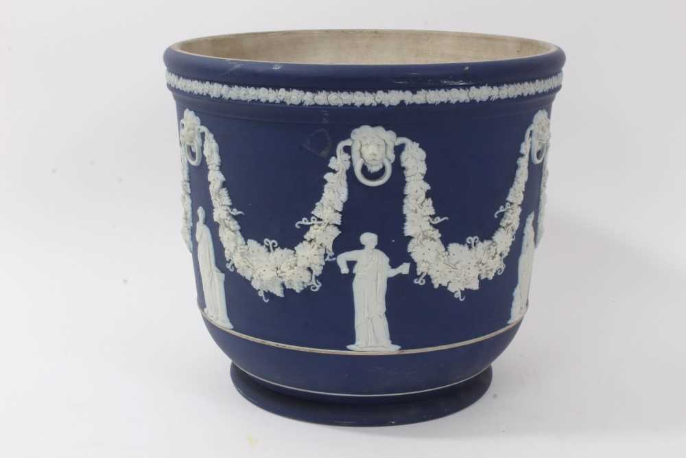 Lot 46 - Large antique Wedgwood dark blue jasper ware jardinière, circa 1890, decorated with classical figures and swags, marks to base, 23cm height x 26cm diameter
