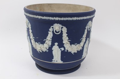 Lot 46 - Large antique Wedgwood dark blue jasper ware jardinière, circa 1890, decorated with classical figures and swags, marks to base, 23cm height x 26cm diameter