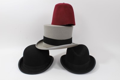 Lot 1809 - Vintage Christy’s London grey felt top hat, Dunn & Co. black felt bowler hat, one other black felt hat and a fez