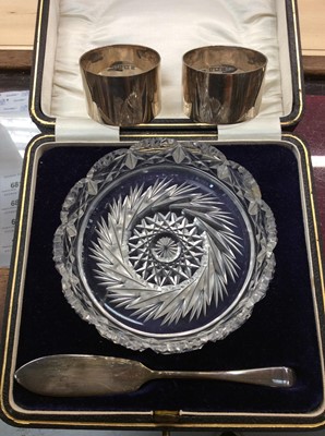 Lot 680 - Cut glass butter dish in fitted case with a silver butter knife together with two silver napkin rings
