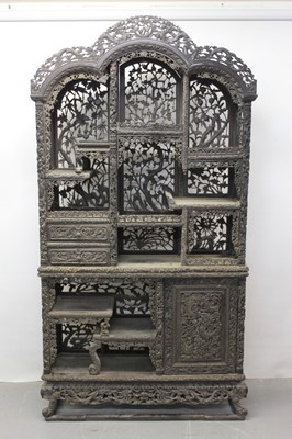 Lot 1235 - Late 19th century Chinese carved hardwood two height open display cabinet