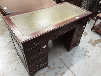 Lot 906 - Reproduction mahogany twin pedestal desk with tooled green leather top and an arrangement of nine drawers below on bracket feet