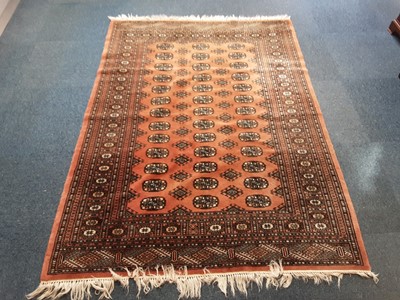Lot 885 - Eastern rug with geometric decoration on peach ground 185cm x 134cm