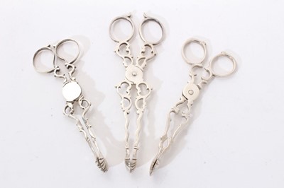 Lot 302 - Three pairs of Georgian style sugar nips of typical form with shell bowls (London 1898/1904) one pair unmarked. All at approximately 3ozs. Largest pair 14cm.