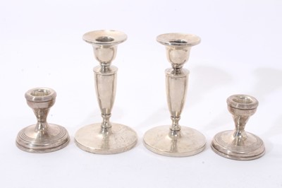 Lot 310 - Pair 1940s silver candlesticks with tapering stems and circular pedestal bases (Birmingham 1949) Henry Clifford Davis. Together with a pair contemporary silver dwarf candlesticks (Birmingham 1977)....