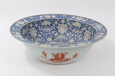 Lot 122 - Large antique Chinese porcelain bowl, circa 1900, decorated with bats, fish and foliate patterns on a dark blue ground, 41cm diameter