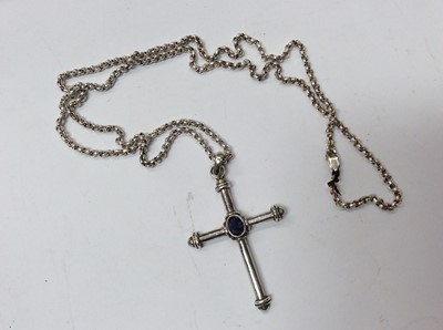 Lot 699 - Silver cross pendant mounted with oval mixed cut purple stone, on silver chain