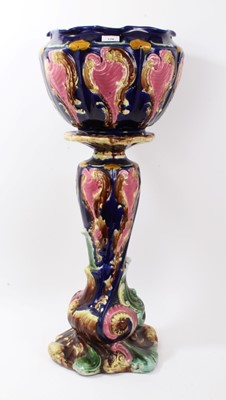 Lot 170 - Victorian majolica relief moulded jardinière and stand, depicting cartouches and foliate scrolls, total height 85cm