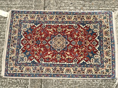 Lot 1410 - Persian style part silk rug, with claret red ground and arabesque ornament.120 x 73cm