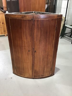 Lot 23 - George III mahogany bowfront corner cabinet enclosing painted interior with three fixed shelves
