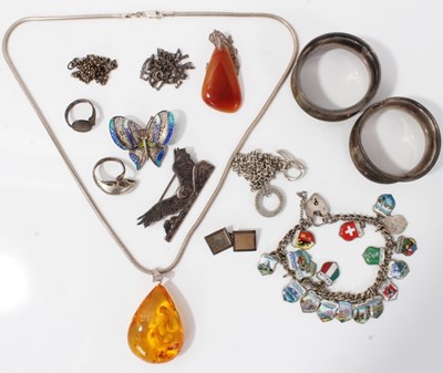Lot 41 - Continental silver and enamel souvenir charm bracelet, other silver jewellery and two silver napkin rings