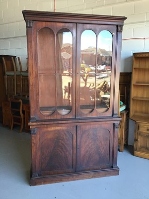 Lot 42 - 19th century mahogany two height bookcase with two glazed doors above enclosing four adjustable shelves and two panelled doors below on plinth base H236cm W137.5cm D44cm