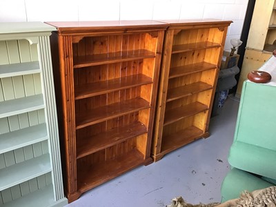 Lot 53 - Pair of stained pine open bookcases with solid panelled backs and four fixed shelves on bracket feet.