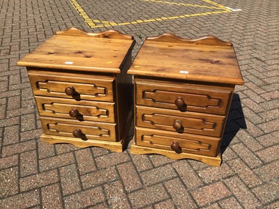 Lot 56 - Pair of stained pine bedside chests with three drawers H56cm W54cm D44cm