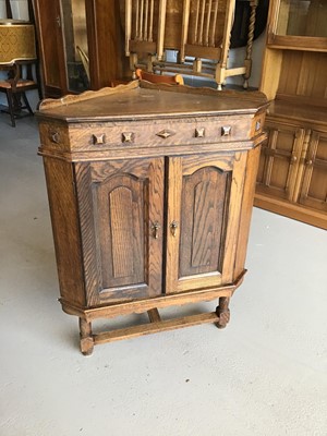 Lot 65 - Oak corner unit with two panelled doors enclosing one fixed shelf H102cm W78cm D49cm