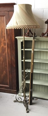 Lot 124 - Brass standard lamp with cream shade on scroll paw feet together with a selection of snooker cues