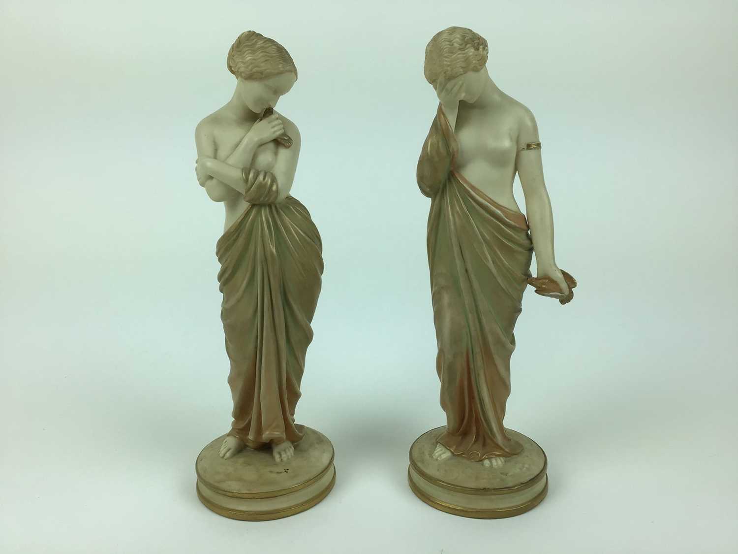 Lot 22 - Pair of Royal Worcester Blush ivory semi clad female figures