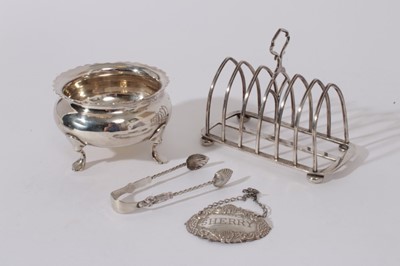 Lot 217 - George V Silver six division toast rack (Birmingham 1919) together with a silver sugar bowl raised on four hoof feet (London 1922), late Victorian silver sugar  tongs (Birmingham 1901)