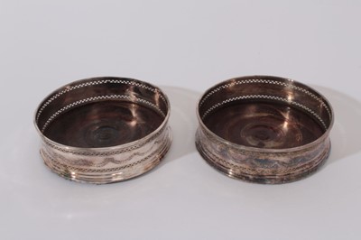Lot 213 - Pair of Georgian old Sheffield plate wine coasters with pierced decoration on turned wood bases