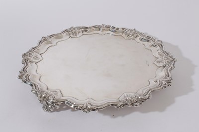 Lot 208 - Edwardian silver salver with foliate, floral and scroll border, raised on three scroll feet, (Sheffield 1909), Maker, Walker & Hall, 27oz, 32cm in diameter