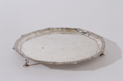 Lot 209 - Contemporary silver waiter with pie crust edge and decorative border, raised on three hoof feet, (Birmingham 1954), Maker, Adie Brothers, 9.5oz, 20.5cm in diameter
