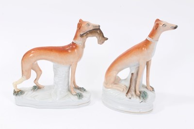Lot 24 - Two Victorian Staffordshire figures of greyhounds, the largest measuring 21cm height