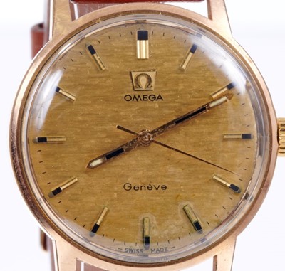 Lot 597 - Gentlemen's Omega Genève manual wind movement with circular brushed gold dial, applied gold baton hour markers, centre seconds in circular gold plated case with steel screw-back, on brown leather s...