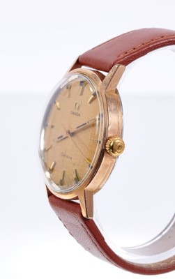 Lot 597 - Gentlemen's Omega Genève manual wind movement with circular brushed gold dial, applied gold baton hour markers, centre seconds in circular gold plated case with steel screw-back, on brown leather s...