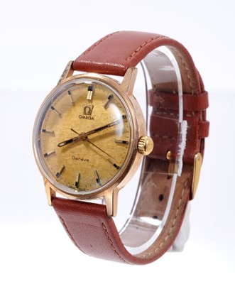 Lot 597 - Gentlemen's Omega Genève manual wind movement with circular brushed gold dial, applied gold baton hour markers, centre seconds in circular gold plated case with steel screw-back, on brown leather s...