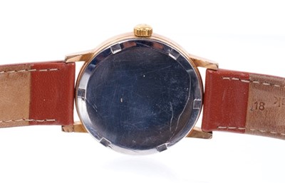 Lot 597 - Gentlemen's Omega Genève manual wind movement with circular brushed gold dial, applied gold baton hour markers, centre seconds in circular gold plated case with steel screw-back, on brown leather s...