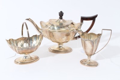Lot 3 - Late Victorian silver three piece bachelor's tea set of navette form, the teapot with ebony finial and angular handle, raised on oval pedestal foot