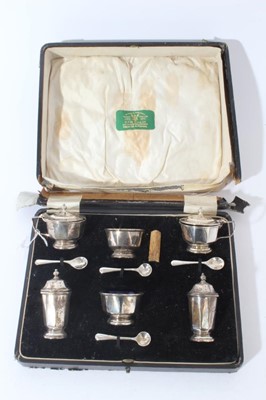 Lot 80 - George V silver six piece cruet set comprising two salt cellars, two pepperettes, two mustard pots (Birmingham 1930), together with four silver salt and mustard spoons