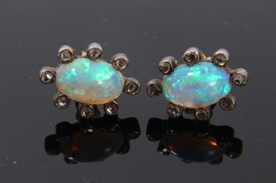 Lot 22 - Pair of antique opal and diamond earrings, each with a opal cabochon surrounded by rose cut diamonds in silver and gold setting