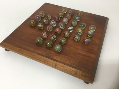 Lot 35 - Victorian solitaire board and marbles.