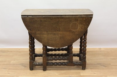 Lot 882 - Late 17th century oak oval gateleg dining table with end drawer on bobbin turned legs