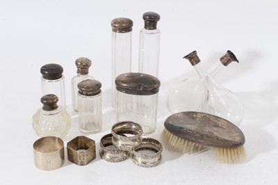 Lot 220 - Three late Victorian silver napkin rings (Birmingham 1900) together with other silver napkin rings, silver topped vanity jars and silver backed brush