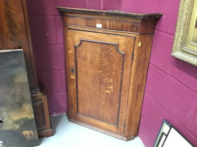 Lot 105 - Georgian oak hanging corner cupboard with dentil cornice , panelled door enclosing three shaped shelves 100 cm high, 75 cm wide